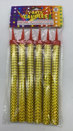 yellow party candles with orange cones in plastic bag on white tableclothed package for sale