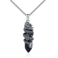 a necklace with a dragon on it and a black stone in the shape of a tooth