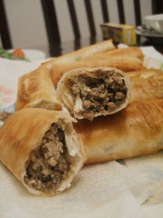 there are two pieces of meat in the pastry on the table next to each other