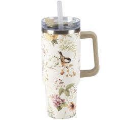 a travel mug with a lid and handle is decorated with flowers, birds and leaves