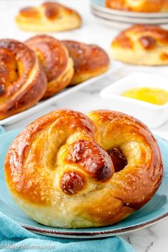 hot dog buns on a plate next to other baked goods