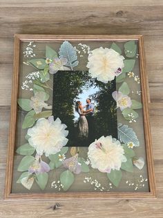 a wooden frame with flowers and leaves on it