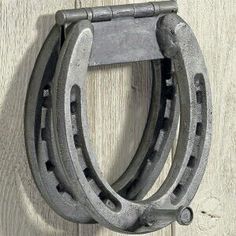 an old pair of horseshoes hanging on a wooden wall