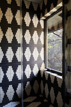 a black and white tiled bathroom with a window