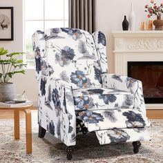 a blue and white chair sitting on top of a rug next to a fire place