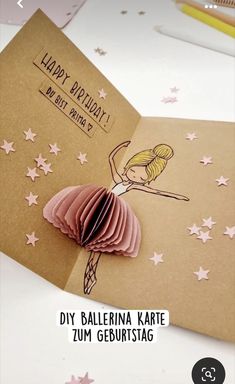 a handmade card with a ballerina on it and pink stars around the edges