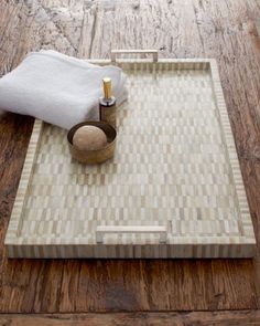 a wooden table with a tray on top of it and a towel next to it