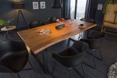 a table with black chairs around it in a room