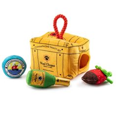 a small yellow box with some toys around it on a white background and an orange rope hanging from the top