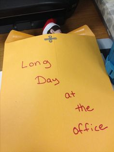 a piece of yellow paper that says long day at the office