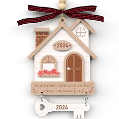 a house shaped ornament with a key hanging from it's front door