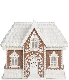 a gingerbread house is decorated with white frosting and icing on the roof