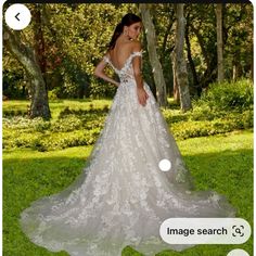 a woman in a wedding dress looking at the camera