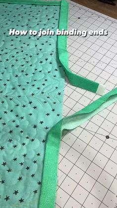 a piece of green fabric with black stars on it and the words how to join binding ends