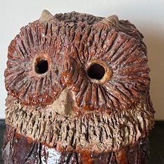 an owl statue is sitting on a table