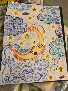 a notebook with an image of the moon and stars on it