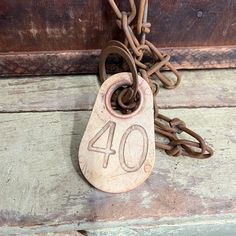 the number forty four is attached to an old padlock with chains hanging from it