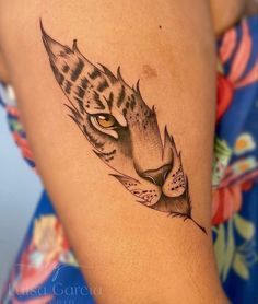 a woman's thigh with a tiger tattoo on it