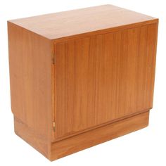 a wooden cabinet sitting on top of a white floor