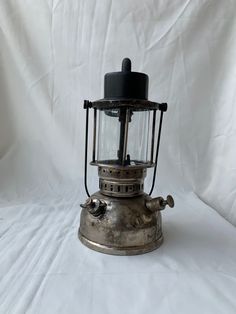 an old fashioned metal lantern on a white background