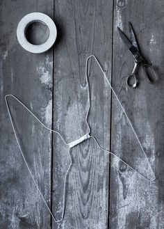 a pair of scissors and some tape on a wooden table