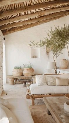 a living room filled with lots of white furniture