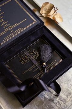 a black box with a tassel on top of it