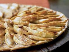 an apple pie is shown on a wooden platter