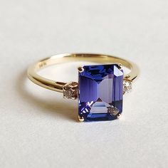 This stunning ring is set in 14k Solid Yellow Gold with Natural Tanzanite and Diamond with utmost precision. It is an unique statement gemstone ring for nearly every occasion and is completely hassle-free jewelry. ITEM DETAILS * CENTER GEM: Tanzanite * GEM SIZE: 7X9mm * GEM SHAPE: Octagon Rectangle * GEM WEIGHT: 2.288 carats * SIDE GEM: Diamond * GEM SIZE: 2mm  * GEM SHAPE: Round * GEM WEIGHT: 0.071 carats * Total GEM WEIGHT: 5.18 carats * Gold Purity: 14KT * Gold Weight: 2.359 gram * Total Weig Ring My Bell, Tanzanite Engagement Ring, Tanzanite Jewelry, Handmade Jewelry Box, Tanzanite Diamond Ring, Future Engagement Rings, Tanzanite Diamond, Solid Gold Ring, Tanzanite Ring