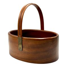 a wooden basket with leather handles on a white background