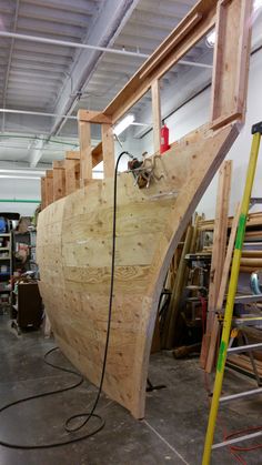 a wooden boat being built in a shop