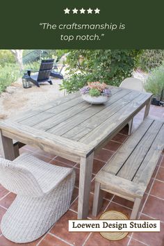 a wooden table sitting on top of a red tile floor