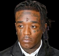 a man with tattoos on his face and tie