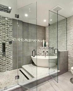 a modern bathroom with glass walls and stone flooring on the wall, along with a white toilet