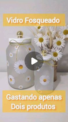 two jars with daisies in them sitting next to each other