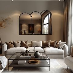 a living room filled with furniture and a large mirror on the wall above it's headboard