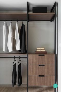 an open closet with clothes hanging on the shelves