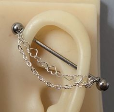 Beautiful decorative chain piece to add onto an industrial barbell, industrial or scaffolding Ear Piercing Chain - BARBELL NOT INCLUDED Handmade ear piercing scaffolding piercing chain made from sterling silver or stainless steel ⛓ **Chain only** does not come with a barbell** Hand Made in standard length, hoops size is made to fit a standard 1.2mm/16g or 14g/1.4mm piercing however can be made to fit 1.6mm or bigger please message me if you need the hoops to be made bigger for bigger gauges  Thi Chain Industrial Piercing, Ear Piercing Chain, Chain Industrial, Scaffold Piercing, Scaffolding Piercing, Piercing Chain, Industrial Piercing Jewelry, Pretty Ear Piercings, Barbell Piercing