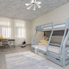 a bedroom with two bunk beds and a teddy bear sitting on the bottom bunk bed