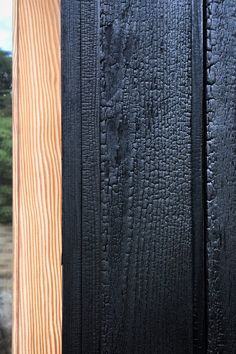 a close up of a wooden door with black paint