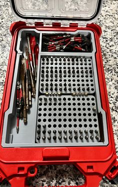 an open red tool box filled with tools