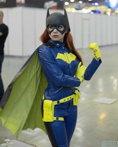 a woman dressed as batgirl posing for the camera