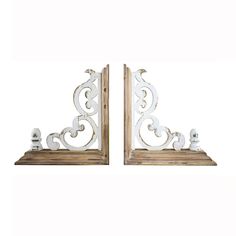 a pair of white iron and wood bookends with carved designs on the sides