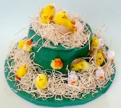 there is a cake decorated with little chicks in the nest on top of grass and straw