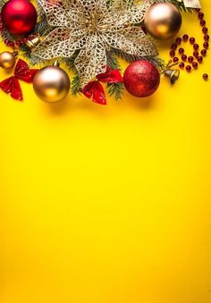 christmas decorations on yellow background with space for text