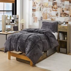 a bed in a bedroom with a gray comforter