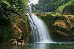 there is a waterfall in the middle of some water