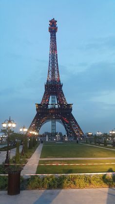 the eiffel tower is lit up at night