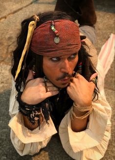 a man dressed in pirate garb and jewelry