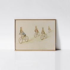 three rabbits riding on bicycles in front of a white wall with a gold framed photo